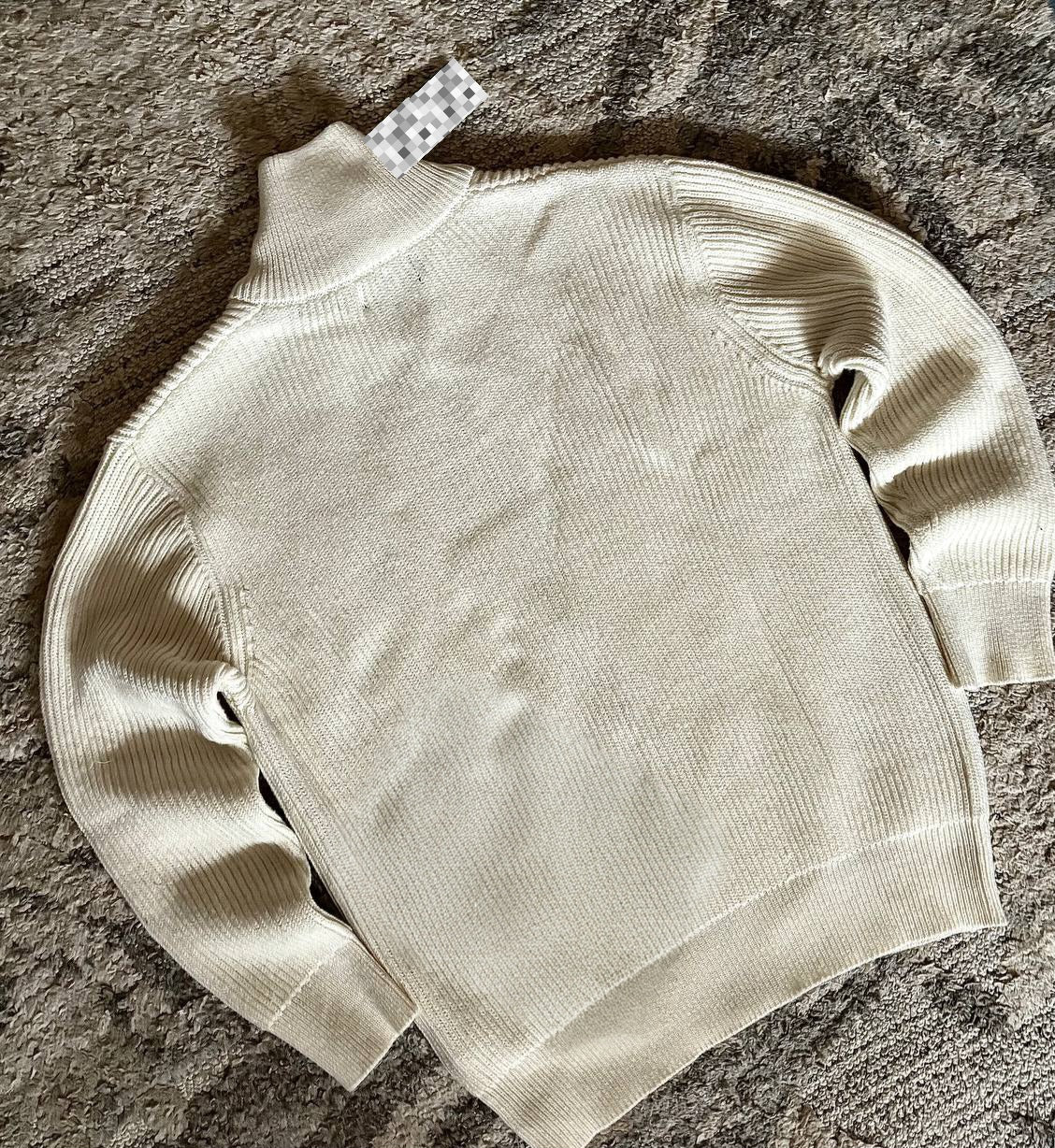 Sweater features a full zip